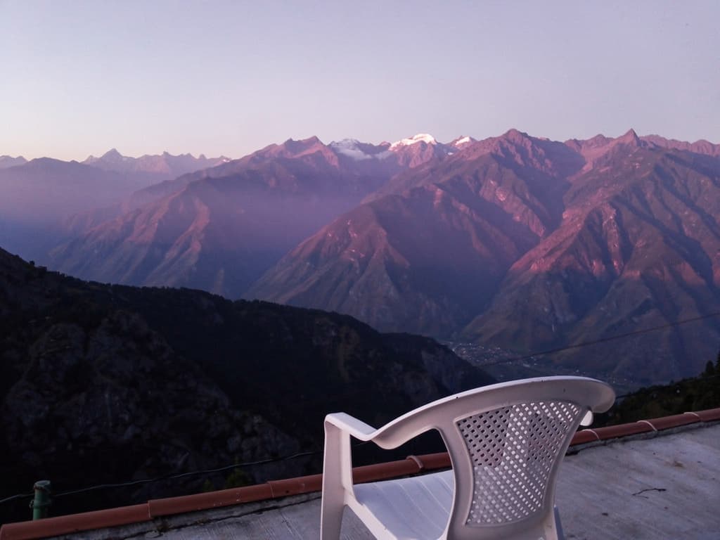 Mountains going purple from Héctor's roof, plastic chair in foreground
