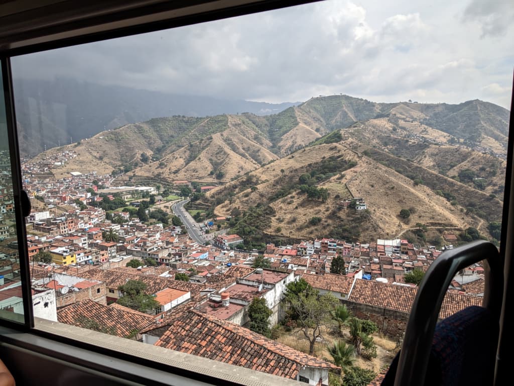 View from the bus window, dry ridges and valley below during the climb to Oaxaca