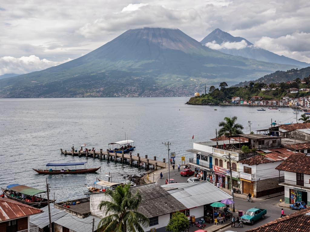 Lake Atitlán from the terminal, grey water and volcanoes behind