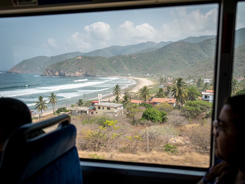 View from the bus window, mountains and dry scrubland on the descent toward the coast