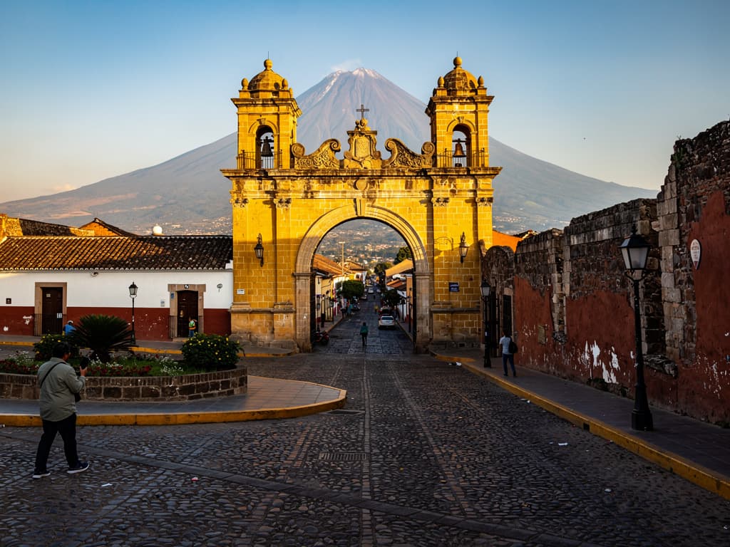 Arco de Santa Catalina in late afternoon, yellow stone under clear sky