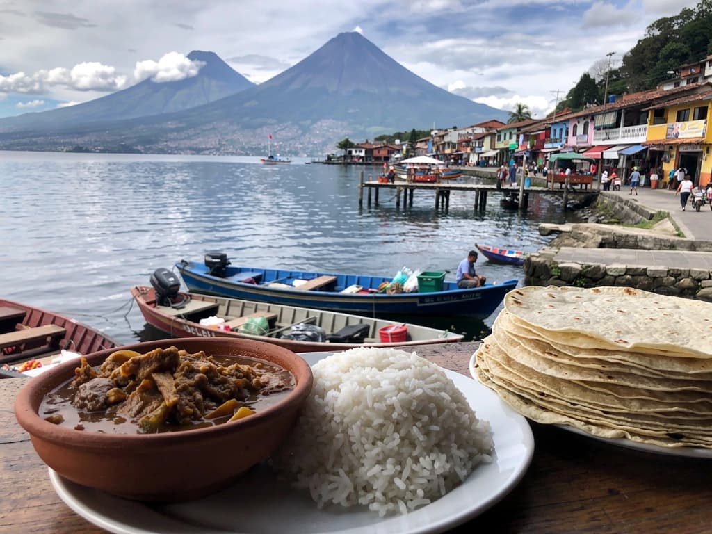 Pepián in a clay bowl at the market comedor, rice on the side, stack of fresh tortillas